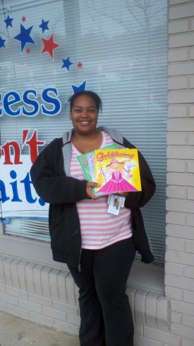 Pictured is Shamiya Thompson of Nemours duPont Pediatrics with just a few of the more than 250 children’s books donated to the program by Success Won’t Wait.