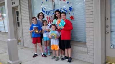 Pictured here are Susan Spartz and RCH Founder Jill Fella with hardworking family members Nicolas, Olivia, Sam and Alex.