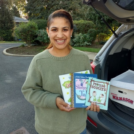 Johanna Vasquez of We Are Their Faces with just a few of the books provided by Success Won't Wait.