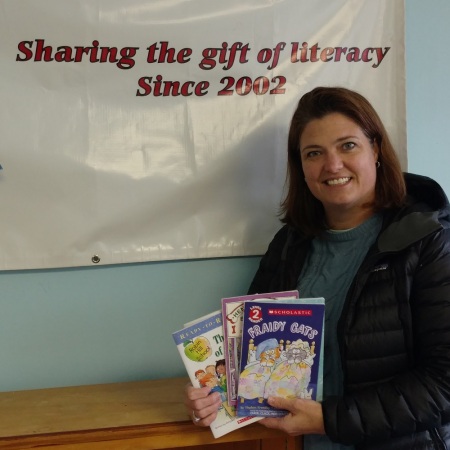 Cristen Zipf, founder of Treasures for Educators with just a few of the books recently donated by Success Won't Wait.